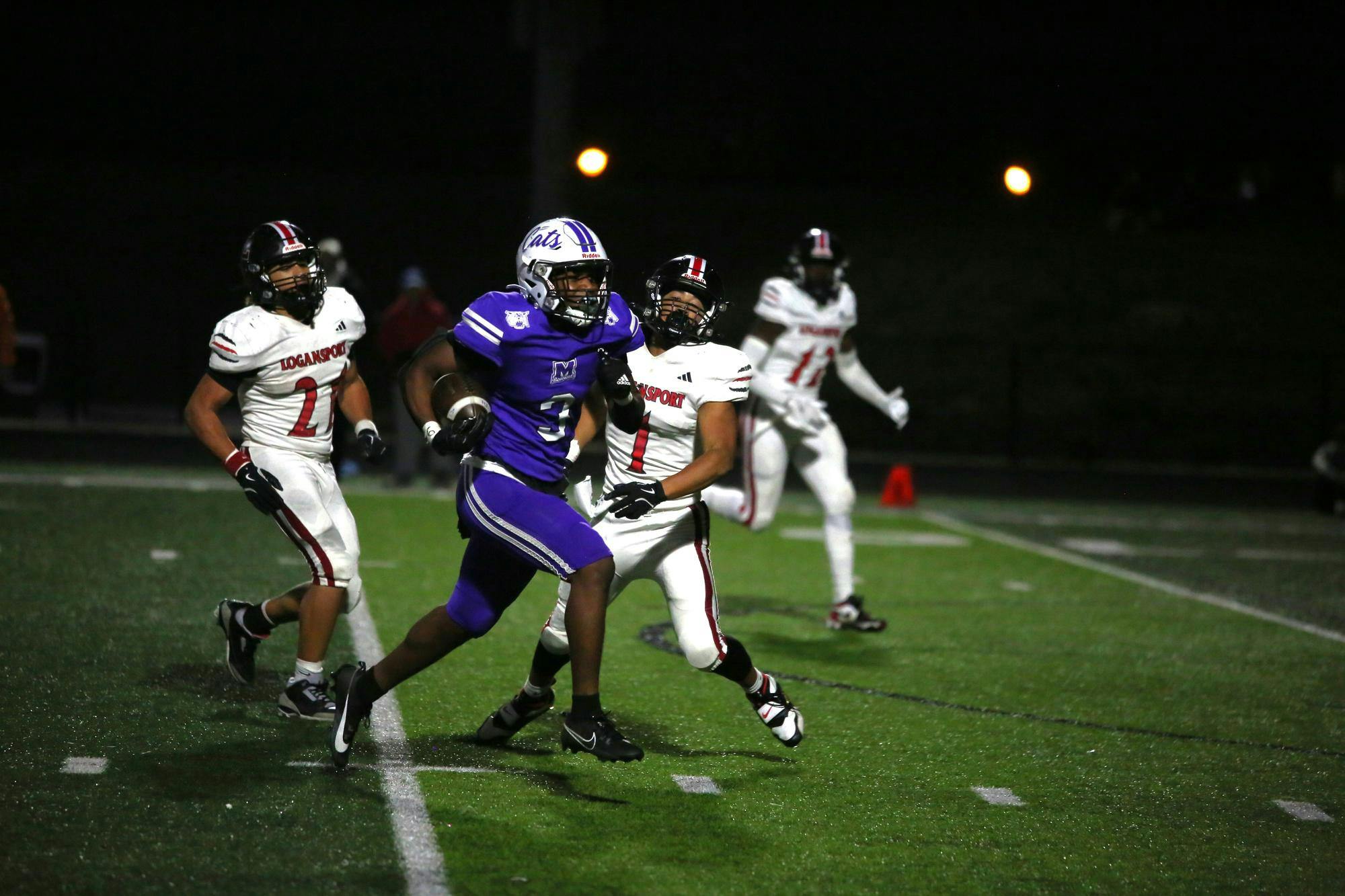 Muncie Central senior running back Landan Johnson runs with the ball in hand en route to a 29-yard rushing touchdown on Oct 31 at Muncie Central. Johnson recorded two touchdowns on the night. Photo by Kyle Stout
