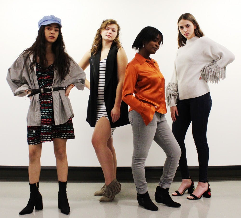 (Left to right): Sophomore Stephanie Gonzalez, freshman Breana Cowan, senior Bria Matemane and freshman Mia Lebo model outfits for the "Thrifty and Thriving" fashion show Saturday. These outfits were designed by up-cycling the articles of clothing donated to the YWCA. Michaela Kelley,DN