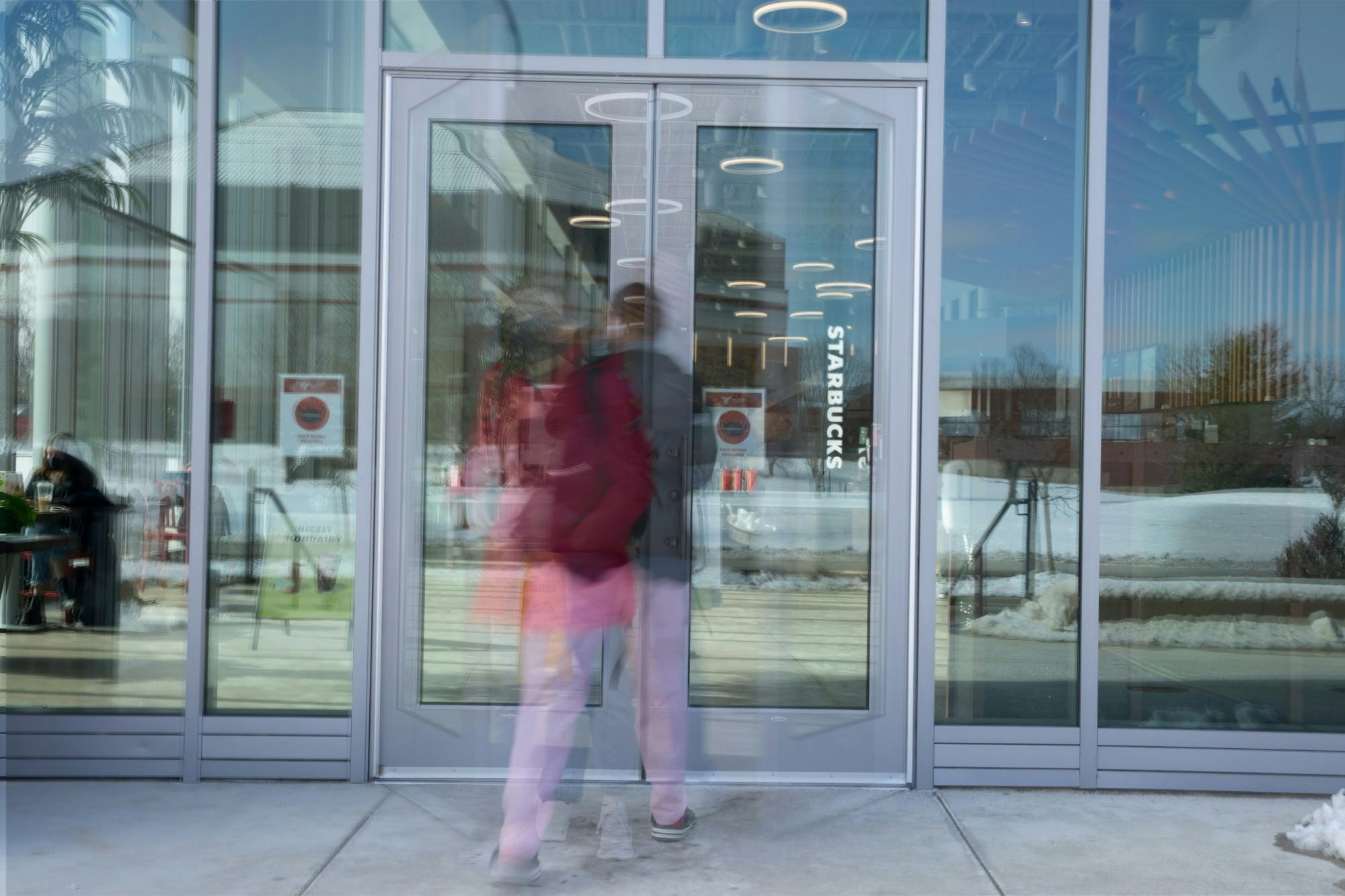 Students walk in and out of the doors at North Dining Hall Feb. 3, 2021. The new dining hall features multiple different new restaurants and an allergen free eatery. Jacob Musselman, DN Photo Illustration