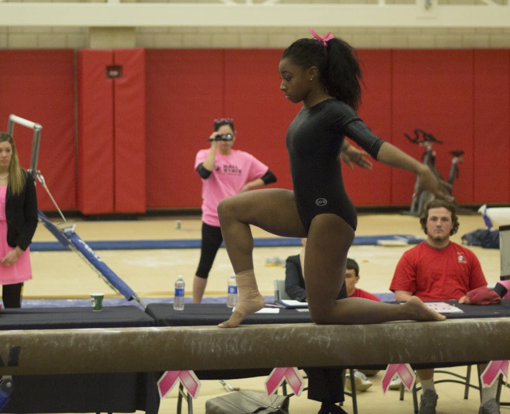Sophomore Denashia Christian begins her beam routine during the meet against Kent State on Feb. 21. DN PHOTO EMMA ROGERS