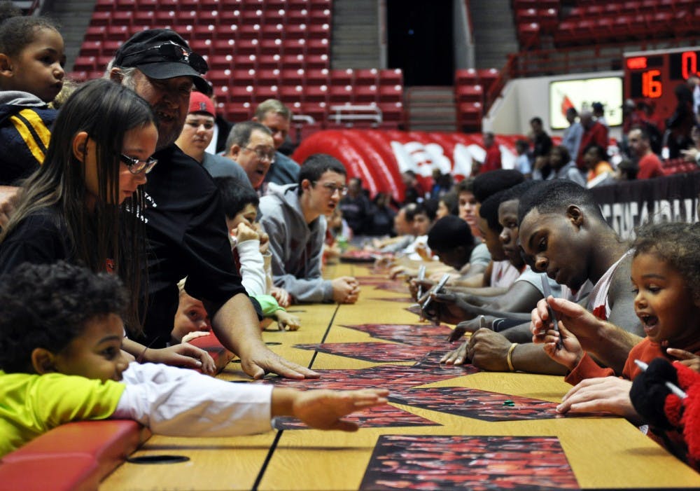 Members of the basketball teams sign autographs at the Fan Jam on Monday evening. Both the men