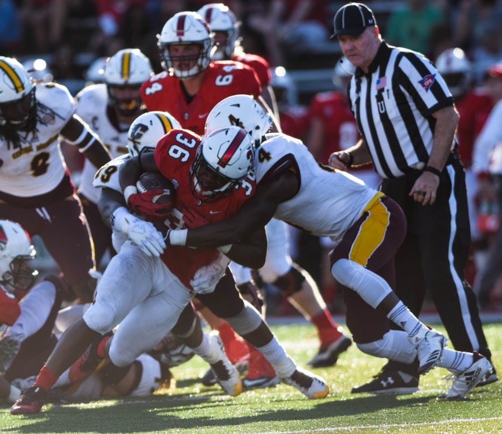 <p>Running Back Caleb Huntley gets tackled by Jamil Sabbagh during the Homecoming Game against Central Michigan on Oct. 21 at Scheumann Stadium. The Cardinals lost 9-56. <strong>Rachel Ellis, DN</strong></p>