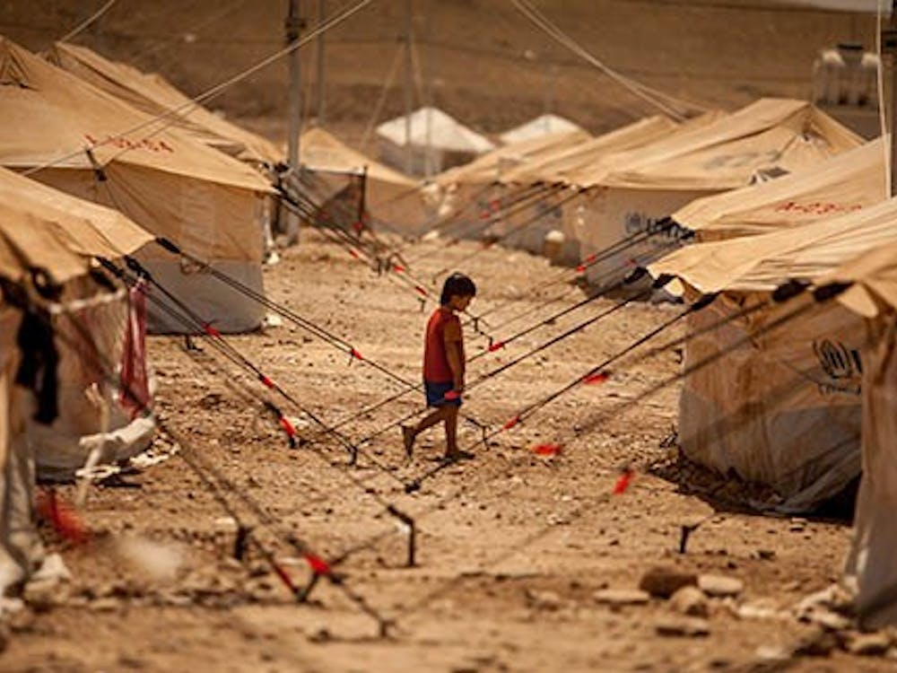 A child walks between dusty tents to look for his family in the Quru Gusik refugee camp set up near the border with Syria on Aug. 24. MCT PHOTO