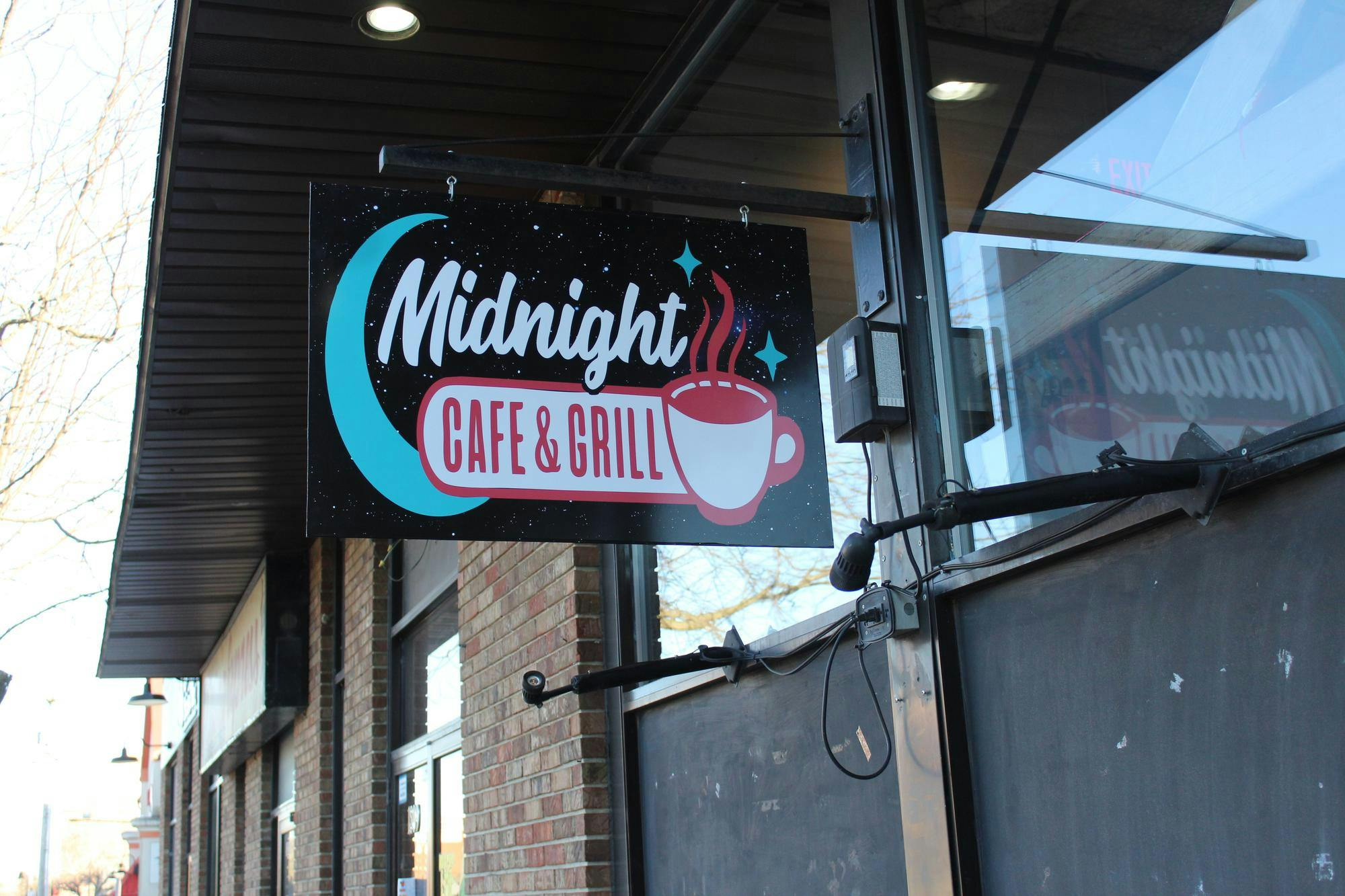 A sign with the logo hangs outside Feb. 20 at the Midnight Cafe & Grill in Muncie, Indiana. Polito envisioned the restaurant as another place for students to hang out rather than a bar scene. Meghan Braddy, DN