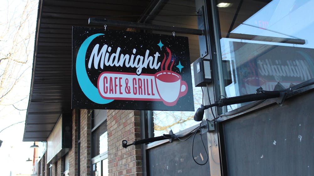  A sign with the logo hangs outside Feb. 20 at the Midnight Cafe & Grill in Muncie, Indiana. Polito envisioned the restaurant as another place for students to hang out rather than a bar scene. Meghan Braddy, DN