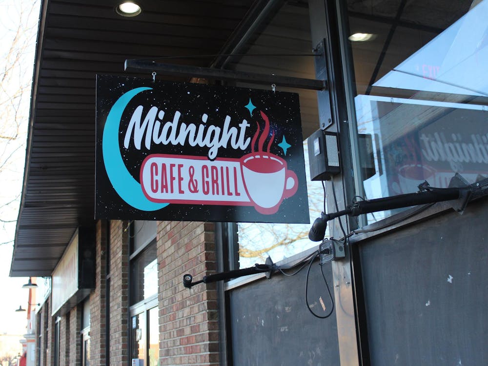  A sign with the logo hangs outside Feb. 20 at the Midnight Cafe & Grill in Muncie, Indiana. Polito envisioned the restaurant as another place for students to hang out rather than a bar scene. Meghan Braddy, DN