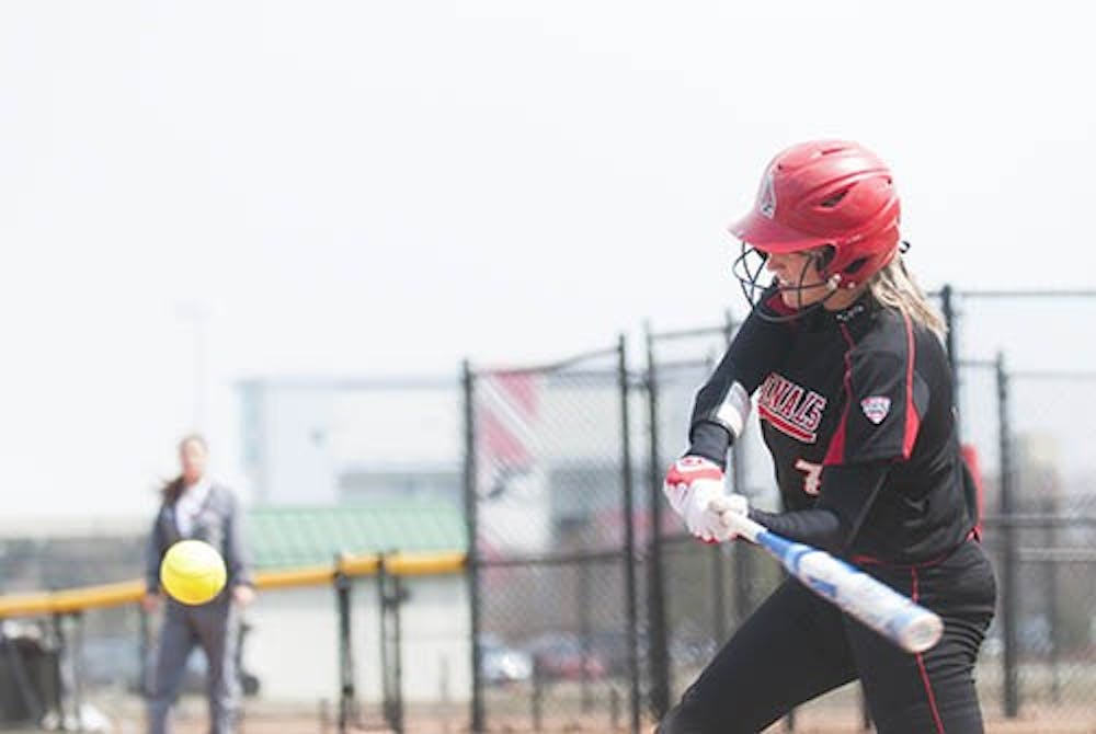  Sophomore Hanne Stuedemann swings at the Western Michigan pitch. DN PHOTO JONATHAN MIKSANEK