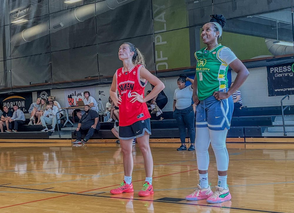 Ally Becki (left) stands on the block next to an opponent as her 'Damien Center' teammate shoots a free throw Wednesday, July 31, at Boner Fitness & Learning Center in Indianapolis. Becki has participated in the Indianapolis-based City League throughout the summer. Kyle Smedley, DN