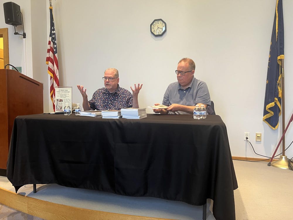 Authors Keith Roysdon (left( and Douglas Walker (right) co-wrote “Cold Case Muncie.” They spoke at an Author Talk event at the Carnegie Library, Tuesday May 14, 2024. Ellie Marker, DN
