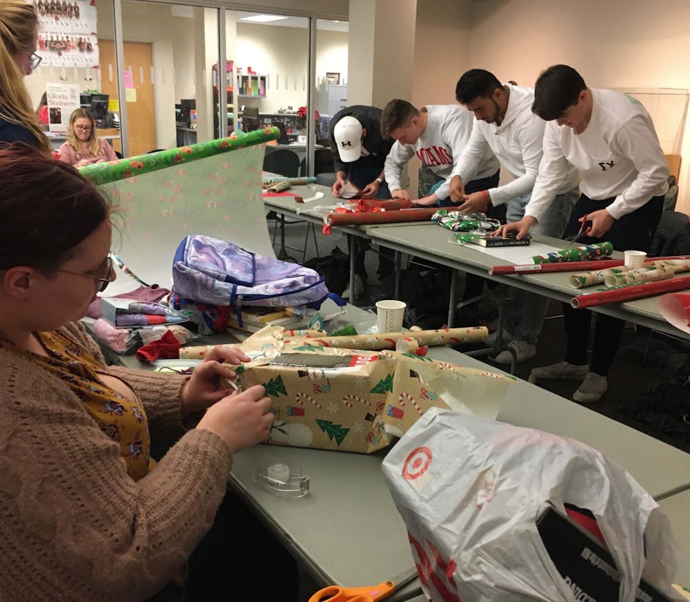 <p>Students help wrap donated gifts for Ball State’s Student Voluntary Services’ annual Angel Tree event Dec. 3, 2019. More than 351 children will receive gifts for the holiday season because students, staff and community members volunteered to sponsor them. <strong>Tier Morrow, DN&nbsp;</strong></p>