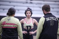 Daleville sophomore Kynlie Keffer talks to her coaches Dec. 18 against Shenandoah at Daleville Junior/Senior High School. This is the first year the IHSAA recognizes girls' wrestling as an official sport. Zach Carter, DN. 