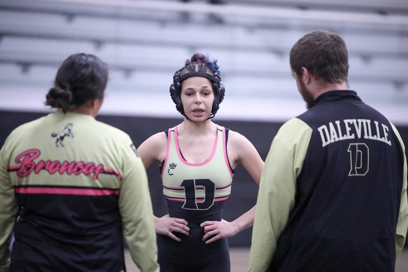 Daleville sophomore Kynlie Keffer talks to her coaches Dec. 18 against Shenandoah at Daleville Junior/Senior High School. This is the first year the IHSAA recognizes girls' wrestling as an official sport. Zach Carter, DN. 