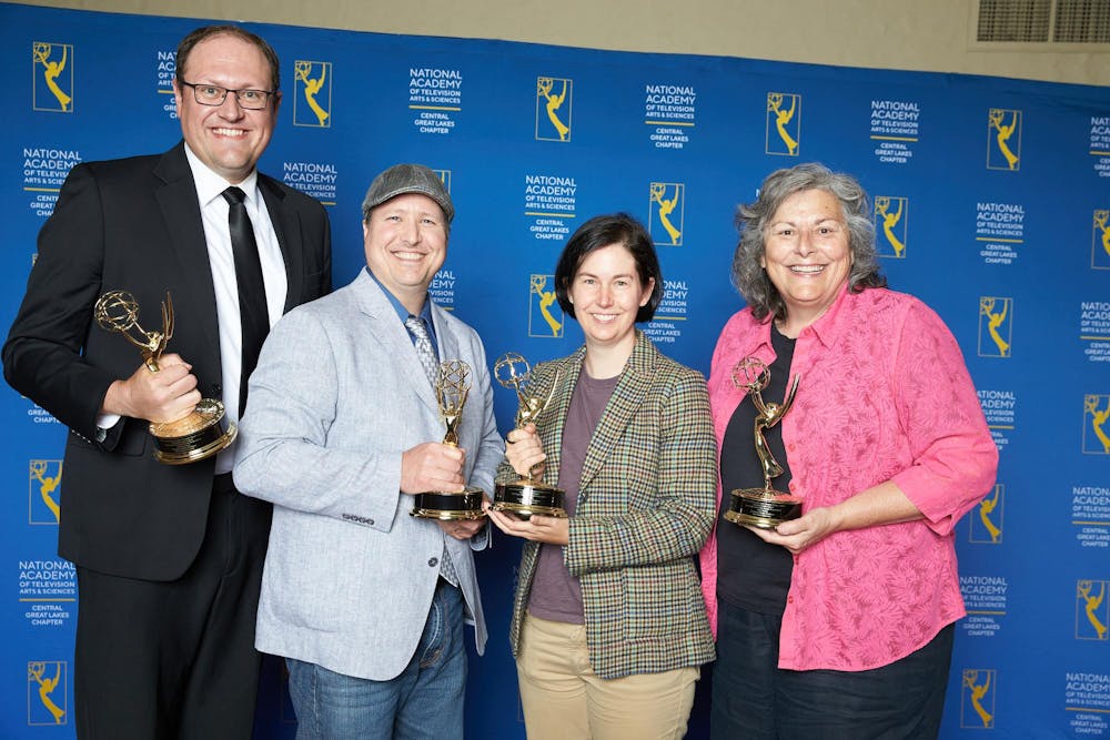 Alex Kartman, Matthew Zeller, Betsy Pike, and Suzy Smith pose for a photo holding regional Emmy awards. ©Monroe Bush_AniMotion Photography, photo provided. 
