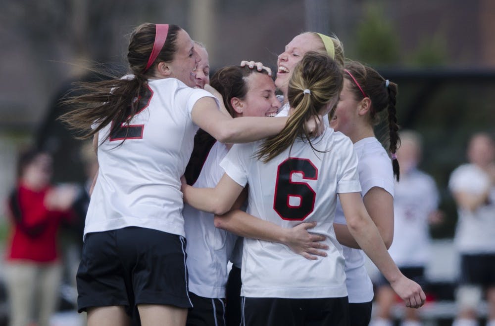 Members of the Ball State soccer team celebrate after scoring a point during the game against the Haiti National team on April 12 at the Briner Sports Complex. DN PHOTO BREANNA DAUGHERTY