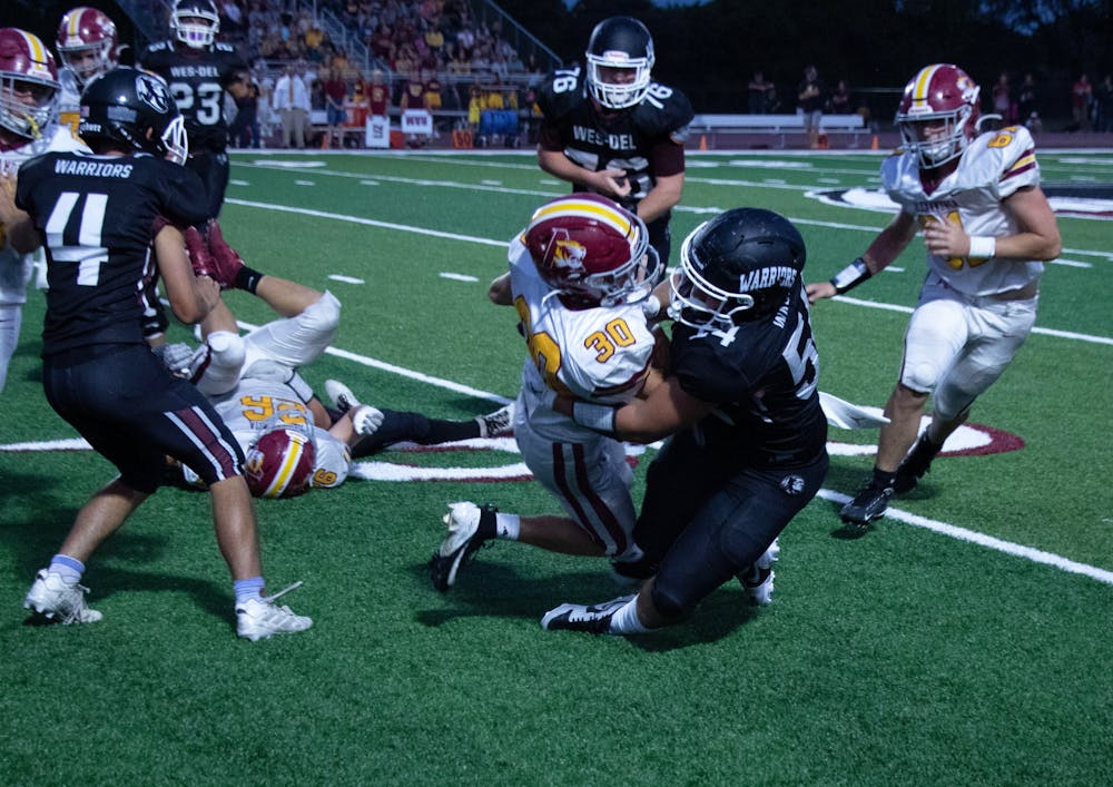 Wes-Del senior Grayson Mealy makes a tackle in a game against Alexandria Aug. 23 at Wes-Del Middle/Senior High School. The Warriors fell to the Tigers 41-12. David Moore, DN