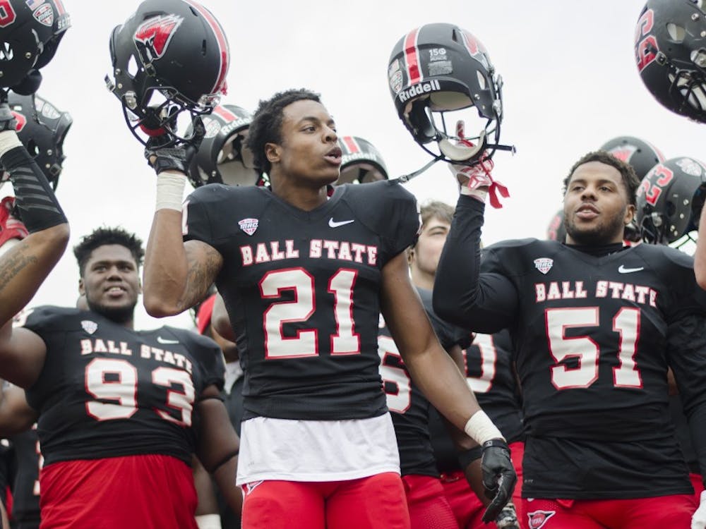 Members of the Ball State football team celebrate after winning the game against the University of Massachusetts on Oct. 31 at Scheumann Stadium. Ball State won 20-10. DN PHOTO BREANNA DAUGHERTY