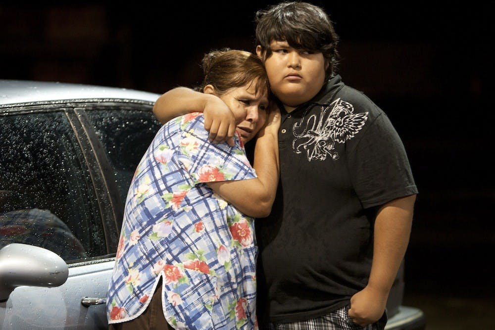 Eva Zapata, left, waits with family member Dario Segura for news of her children, who live in the Granbury, Texas, neighborhood of Rancho Brazos that was evacuated after storms on Wednesday, May 15, 2013. (Joyce Marshall/Fort Worth Star-Telegram/MCT)
