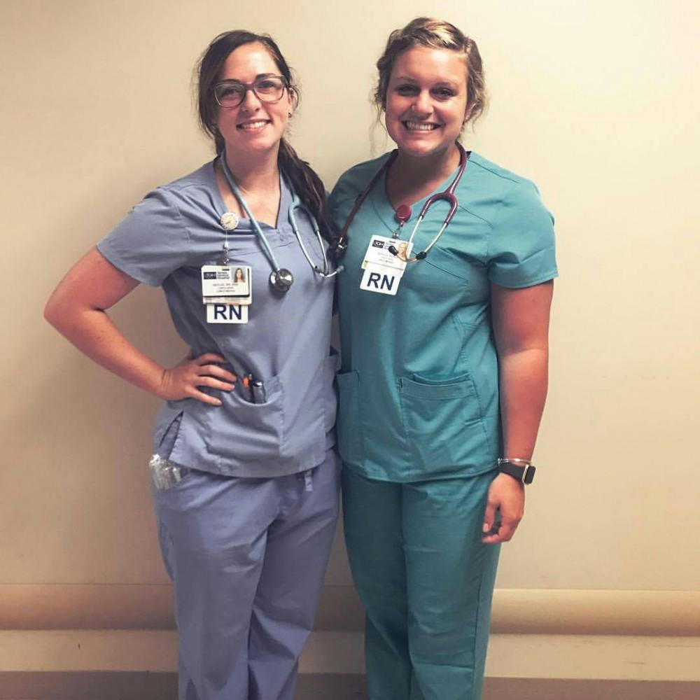 <p>Haylee Mitchel and Jessica Extine take a photo after their 48-hour shift during hurricane Irma at Tampa General Hospital. Mitchell and Extine both graduated from Ball State in May of 2017. <strong>Jessica Extine, Photo Provided</strong></p>