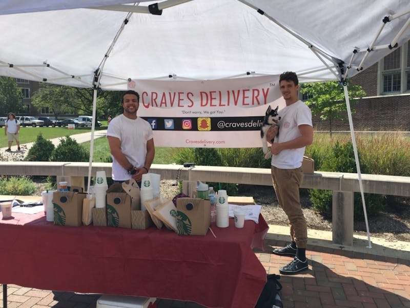 Ball State junior Zachary Cable and former Indiana University student Drew Crowe of Craves Delivery, a snack delivery service, set up their booth at the Scramble Light on Sept. 13. To spread awareness of their company, Cable and Crowe give away free Starbucks, snacks and fliers about every three weeks. Allie Kirkman // DN