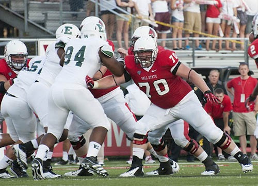 Ball State’s Jordan Hansel attempts to block the other team during a game against Eastern Michigan Aug. 30, 2012. Hansel believes the bond among players will strengthen the offensive line. DN FILE PHOTO JONATHAN MIKSANEK