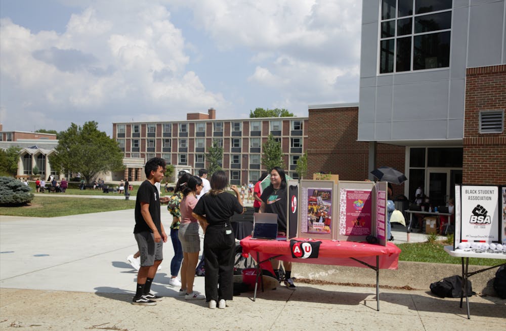 Parker Clingerman, vice president of the Asian Student Union, talks to students at the welcoming celebration Aug. 27. The new multicultural center will be a home for student organizations like ASU, and includes a new library, study spaces and an ice cream shop. Maya Wilkins, DN