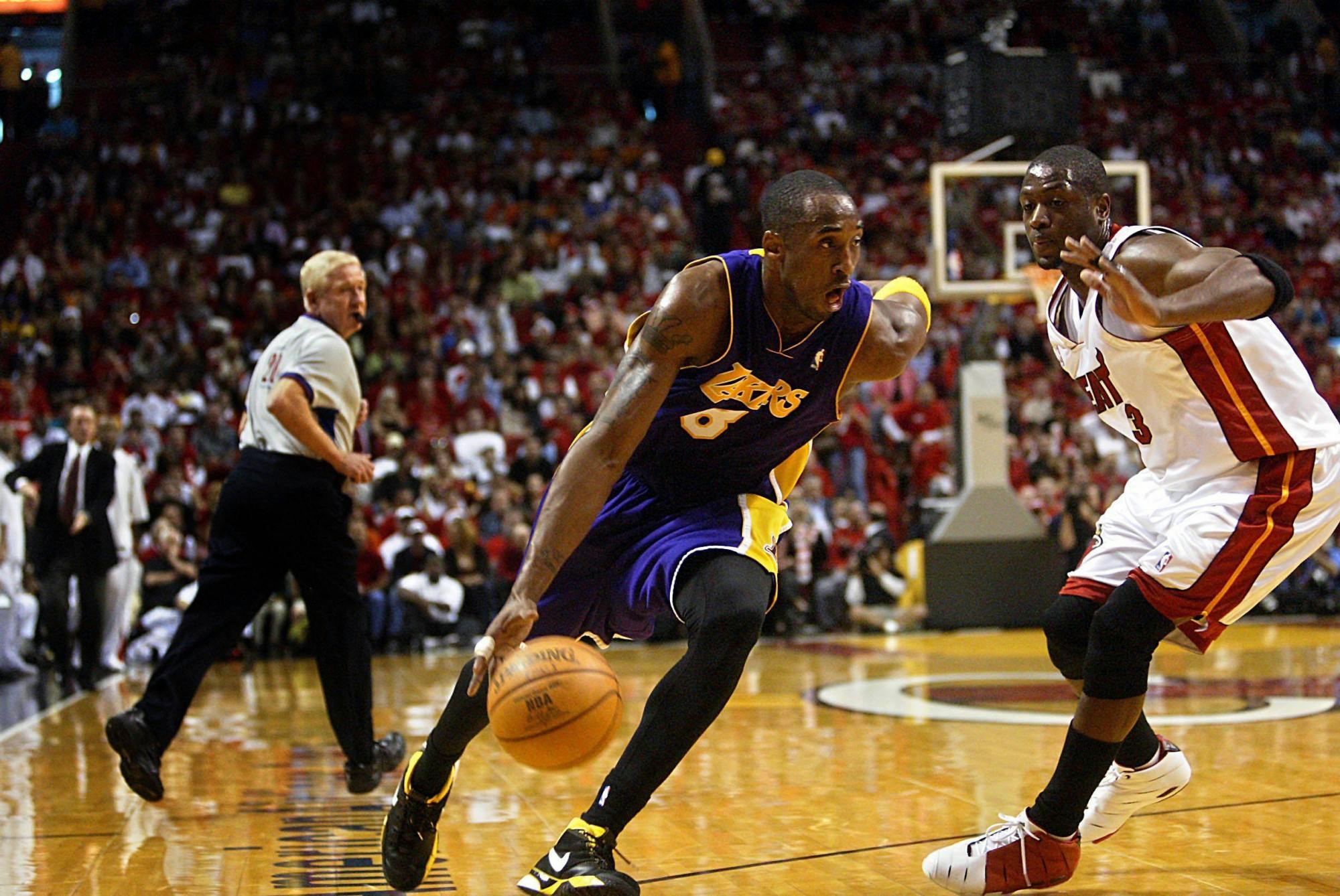 The Lakers' Kobe Bryant drives past the Heat's Dwyane Wade in a 97-92 Heat victory on Sunday, Dec. 25, 2005. Bryant passed away in a helicopter crash Sunday. (DAMON HIGGINS/palmbeachpost.com/ TNS)
