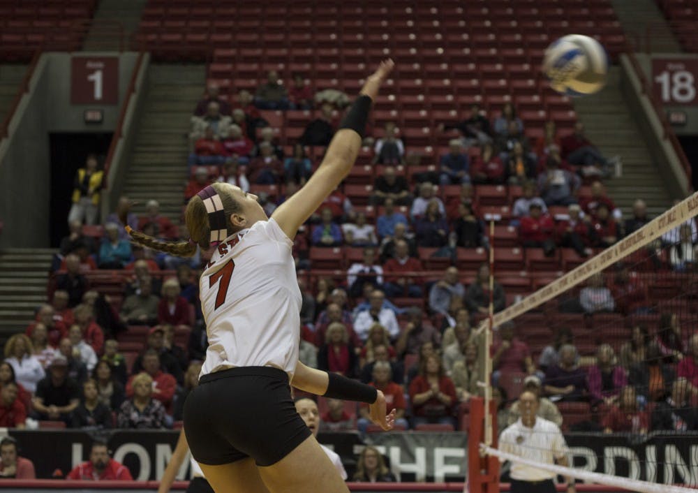 Lauren Grant, a senior opposite hitter, hits the ball over the net during the first set of the match against Eastern Michigan. Ball State won on their senior night 3-0. DN PHOTO EMMA ROGERS