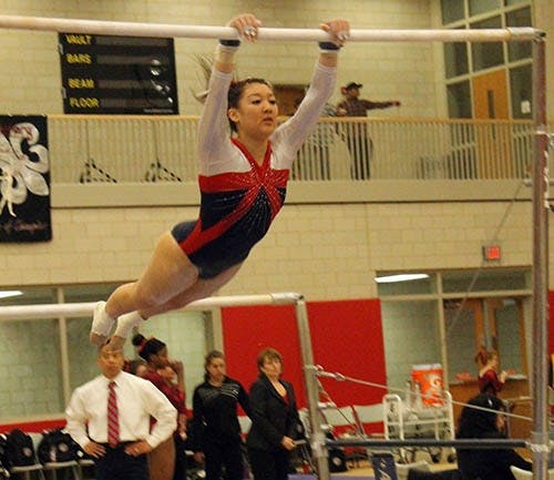 A Penn gymnast completes her bars routine in Friday night's gymnastics meet against Centenary and Ball State. Penn finished second on the night while Ball State took first. DN PHOTO JACQUELYN BRAZZALE