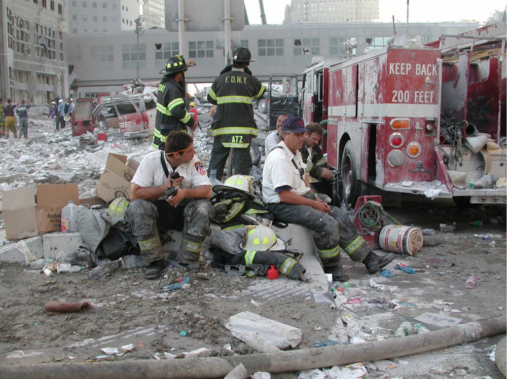 <p>New York City firefighters sit in rubble from the collapsed towers of the World Trade Center Sept. 11, 2001. The New York City Fire Department was one of the first responders on scene when Flight 11 crashed into the north tower. U.S. Army Corps of Engineers, Photo Courtesy</p>