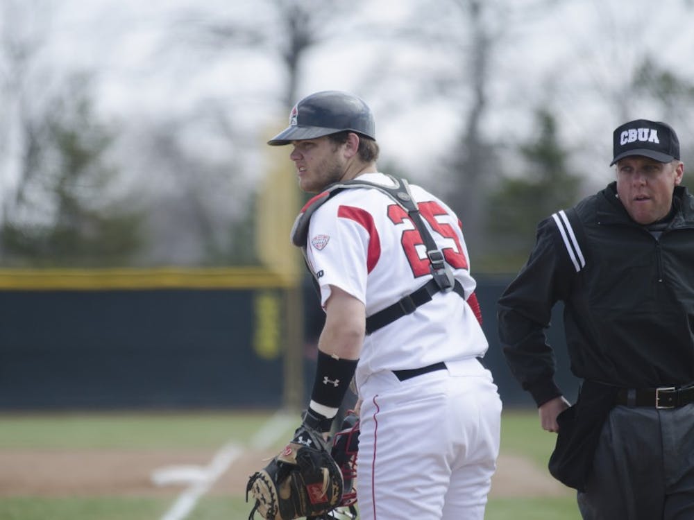 Freshman catcher Jarett Rindfleisch looks towards his coach for a play in the game against Eastern Michigan on April 5 at Ball Diamond. DN PHOTO BREANNA DAUGHERTY 