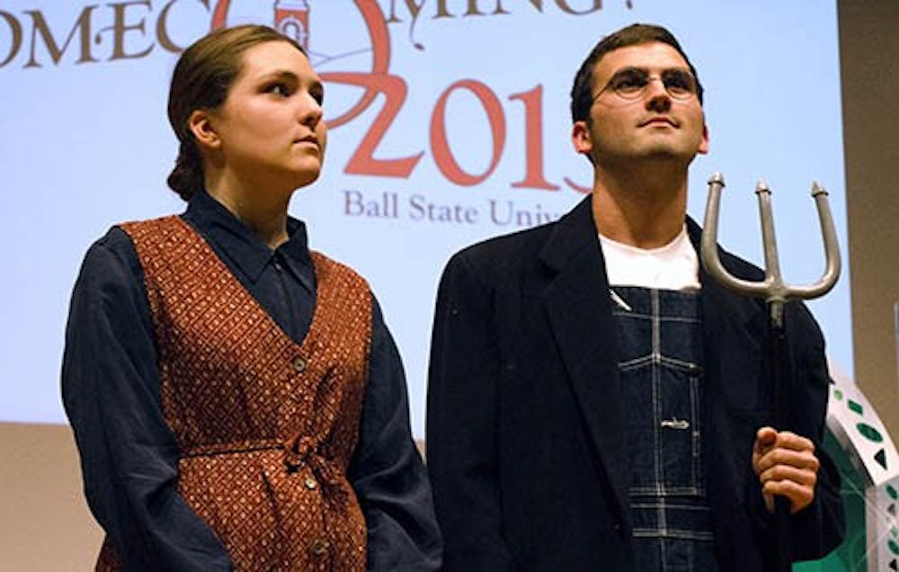 Ellyn Fritz, left, and James Long from Knotts/Edwards Hall pose as the “American Gothic” painting during the Royalty Fashion Show on Monday at Pruis Hall. The fashion show was a kickoff for Homecoming events. DN PHOTO BREANNA DAUGHERTY