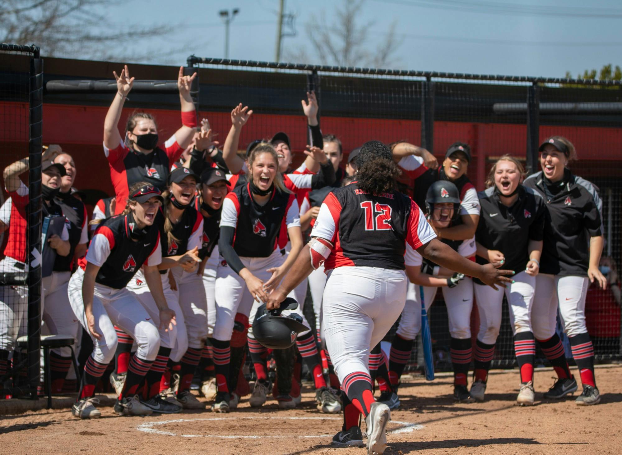 Members of the Cardinals softball team cheer on as graduate student infielder Janae Hogg hits a home run March 27, 2021, at First Merchants Ballpark. Ball State won their first game of the day against the Falcons 7-5. Jaden Whiteman, DN