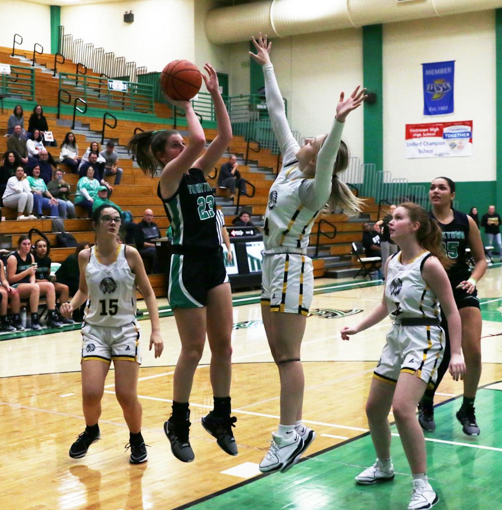 Yorktown sophomore Lilly Syllvester shoots the ball Jan. 9 during the first round of the Delaware County Tournament against Cowan at Yorktown High School. David Moore, DN
