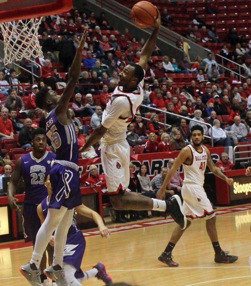 Sophomore guard Jeremie Tyler attempts a slam dunk against Akron players during a game on Jan. 30 at Worthern Arena.  This slam dunk energized the fans.  DN Photo by: Patrick Murphy
