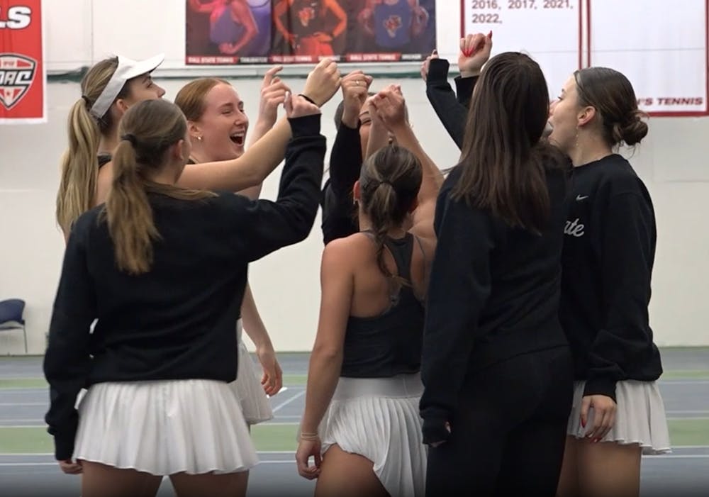 Ball State women's tennis team huddles up during practice.