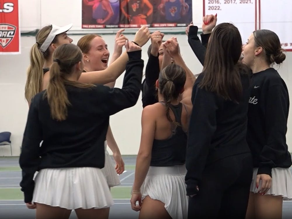 Ball State women's tennis team huddles up during practice.