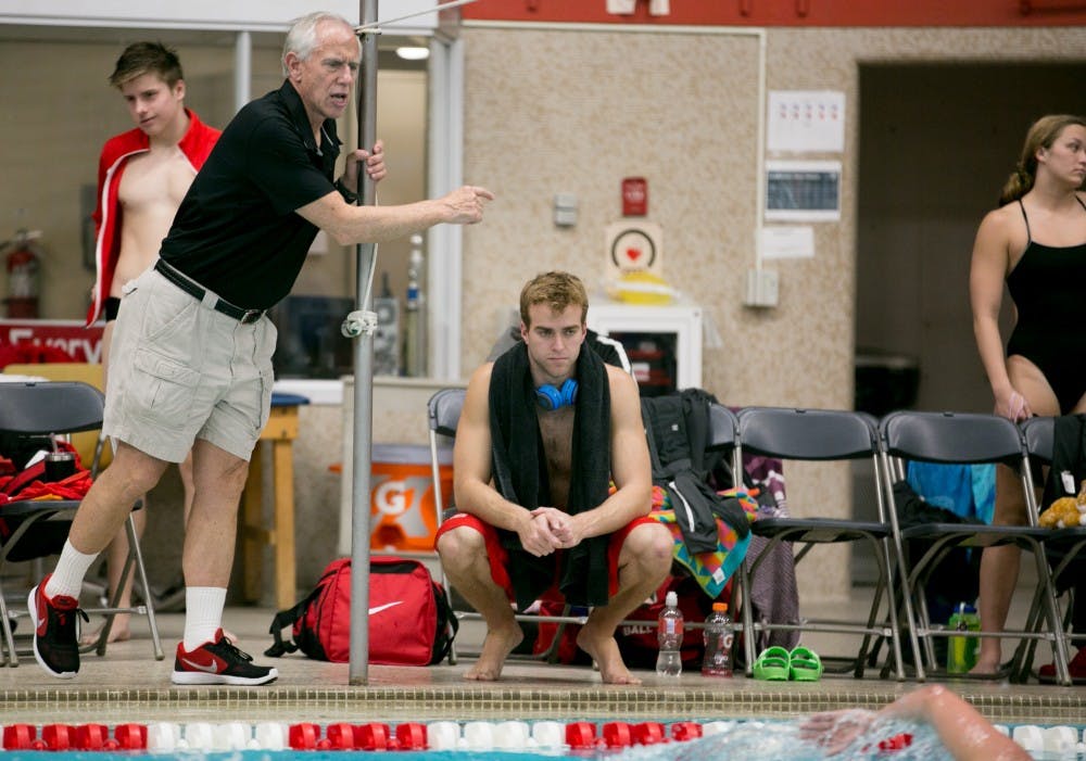 <p>Head Coach Bob Thomas yells for his swimmers during the last 50 yards of the mile during the meet against Grand Valley State on Nov. 18 in Lewellen Pool. <strong>Kaiti Sullivan, DN</strong></p>