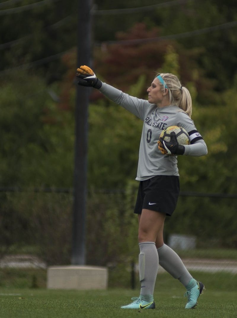 Senior goalkeeper Alyssa Heintschel yells to her teammates before putting the ball back into play against Northern Illinois on Oct. 8 at the Briner Sports Complex. Heintschel had five saves in the game. Breanna Daugherty, DN