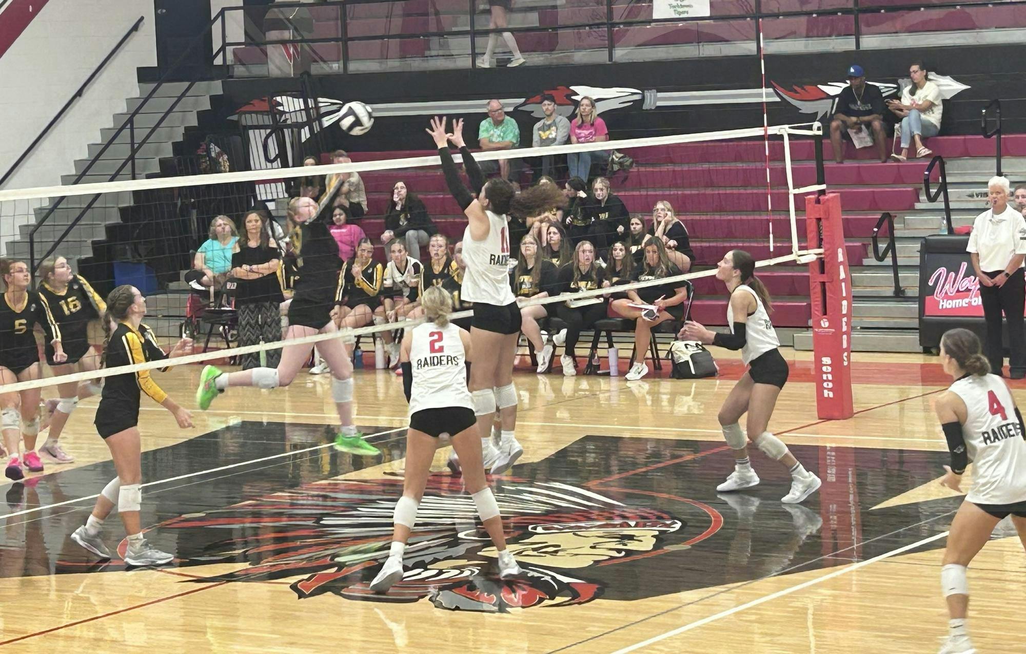 Olivia Walters (#11) goes up to block, leading the Raiders to a 3-0 win. Photo by Kenna Geibel
