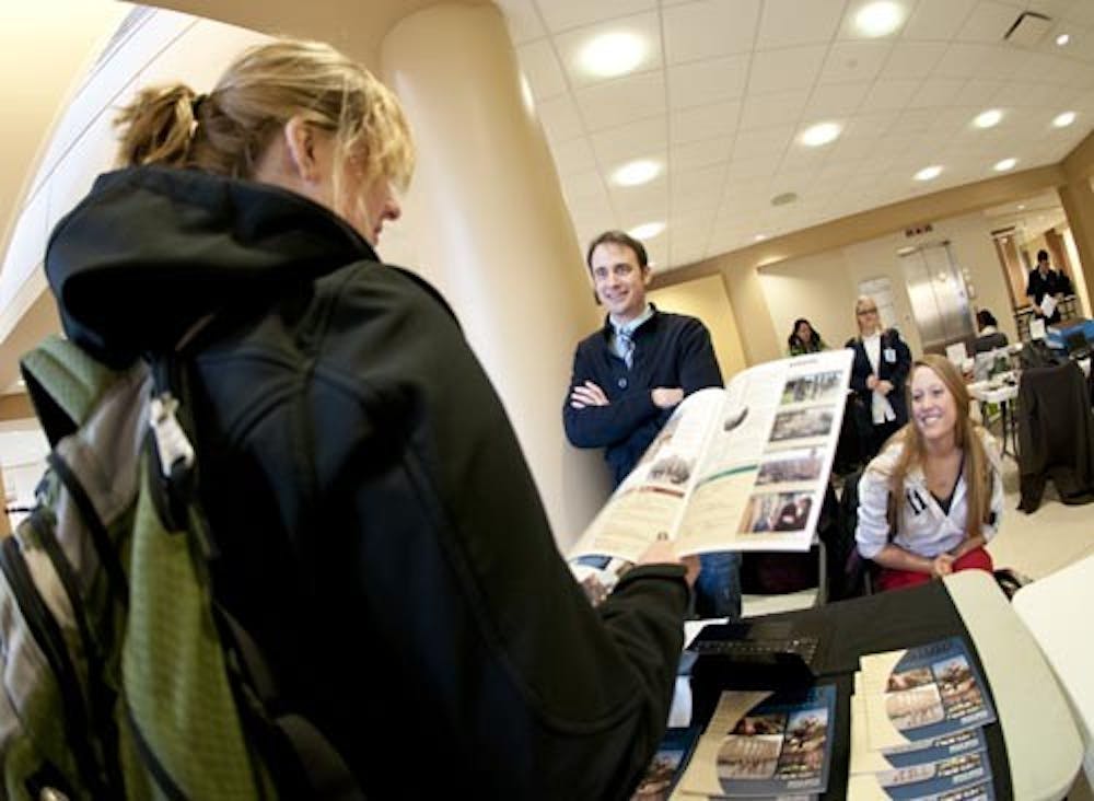 Students visit a variety of tables set up in the Atrium at the Study Abroad Fair on Wednesday. The event ran 10 a.m.-3 p.m. and had faculty and students present to answer questions and talk about travel opportunities. DN PHOTO JONATHAN MIKSANEK
