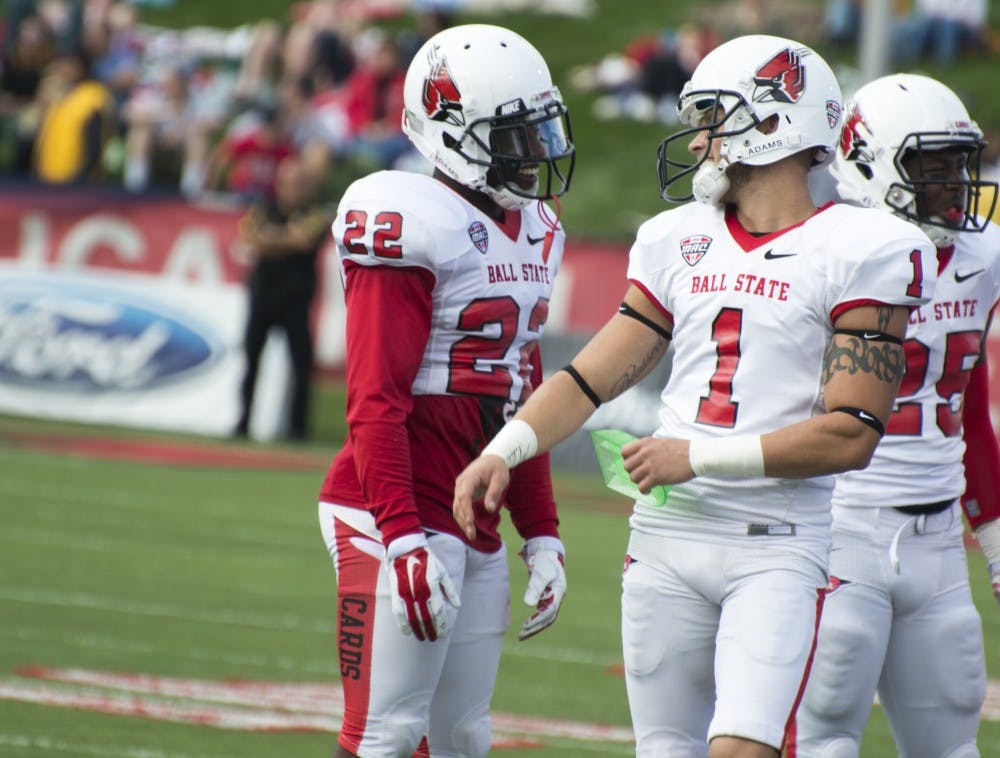 Redshirt senior Scott Secor and senior Quintin Cooper chat between plays at the football game against Indiana State on Sept. 13 at Scheumann Stadium. DN PHOTO ALAINA JAYE HALSEY