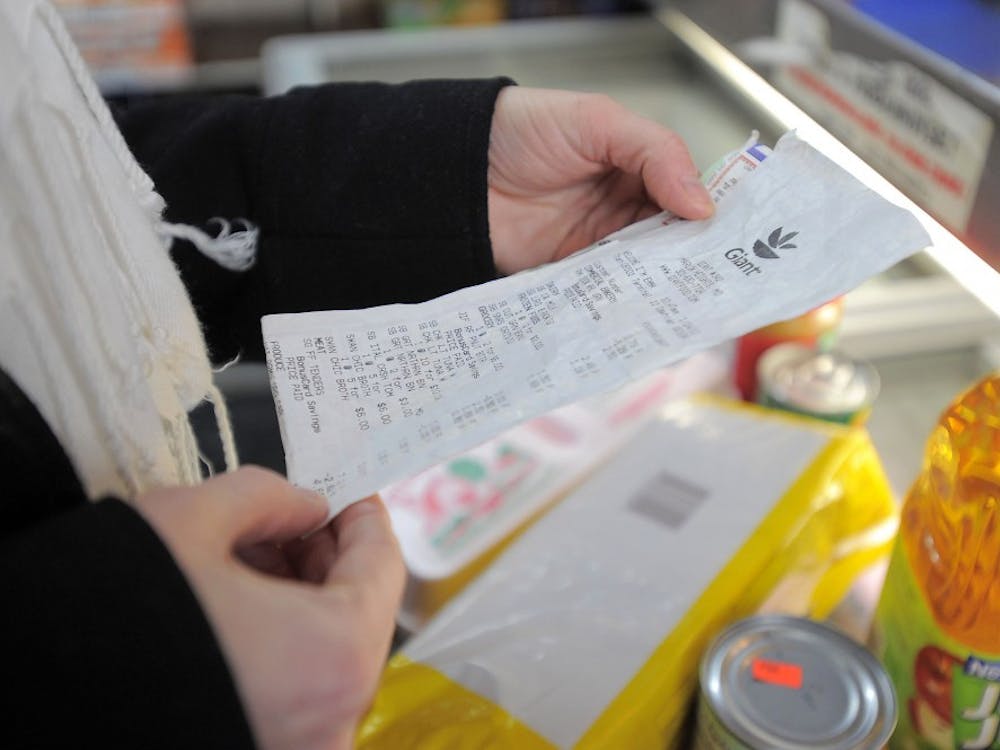 Sarah Shepard-Kneip, program specialist at AARP Maryland, checks her receipt after she shops for groceries at Lee's Food Market in the Sandtown-Winchester community in Baltimore, Jan. 28, 2011. The shopping experiment, conducted at an inner-city neighborhood market, uses $30 to see what food stamp items can be purchased. MCT