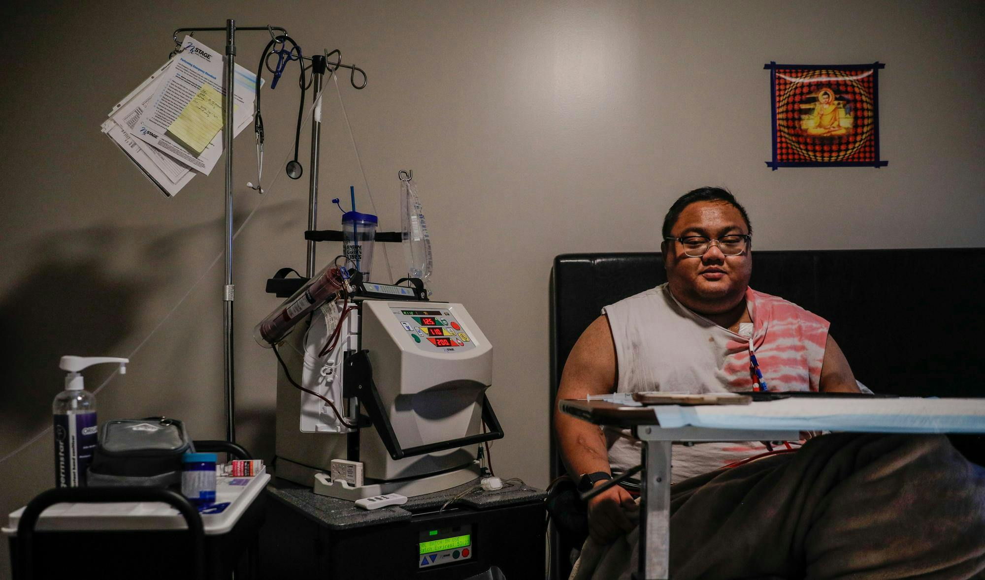 Graduate student Than Win sitting in his room next to the equipment he uses to treat himself Nov. 7 in Beyerl Hall at Ball State. Win has been on dialysis for over three years to treat his Bergers disease. Andrew Berger, DN&nbsp;