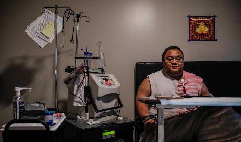 Graduate student Than Win sitting in his room next to the equipment he uses to treat himself Nov. 7 in Beyerl Hall at Ball State. Win has been on dialysis for over three years to treat his Bergers disease. Andrew Berger, DN&nbsp;