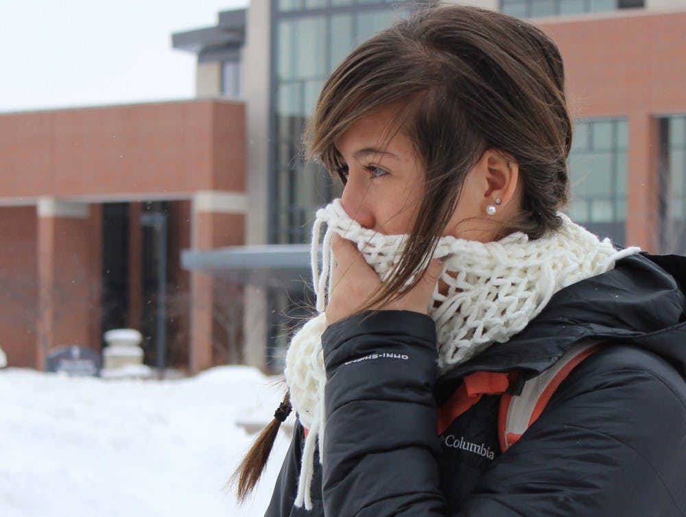 Freshman special education major Sierra Emilson crosses McKinely Avenue after class on Feb. 5. DN PHOTO ALISON CARROLL