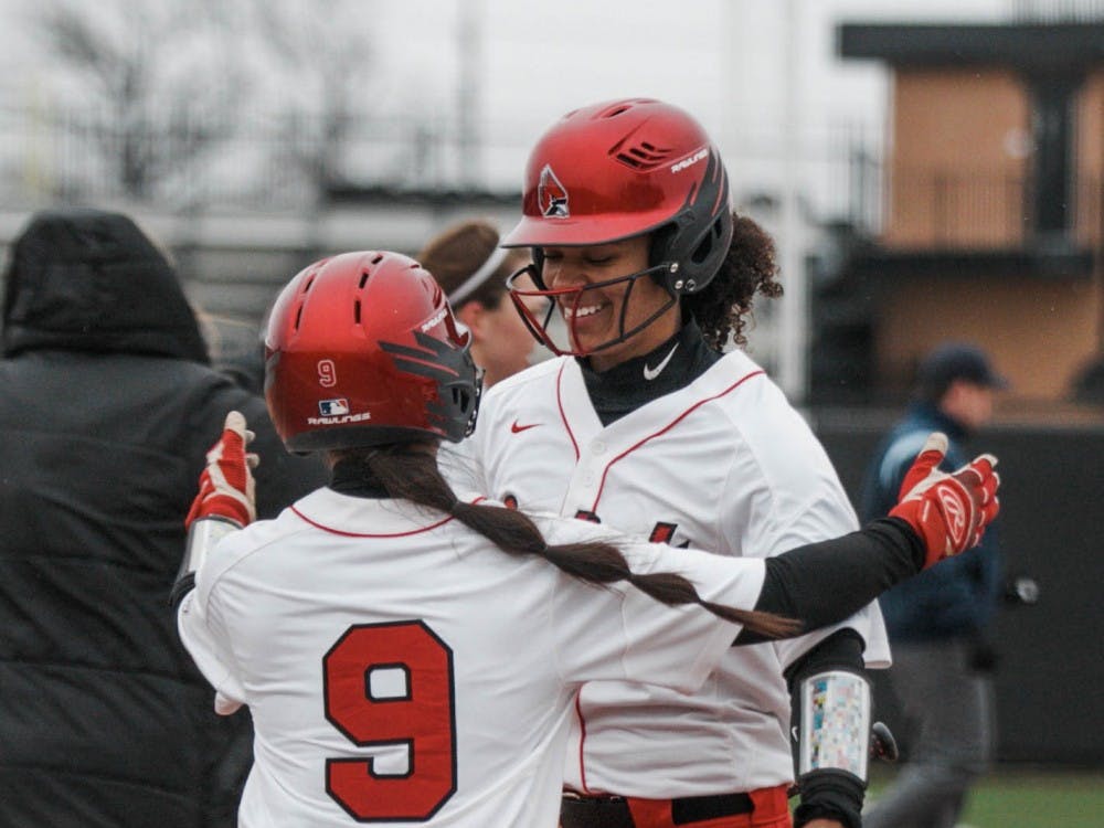 Freshman Hailey Demnianiuk runs in for a hug with sophomore Kennedy Wynn to celebrate their victory. Wynn scored the last point during the Ball State verses Kent State game at the Softball Field at First Merchants Ballpark Complex on April 6. Carlee Ellison, DN