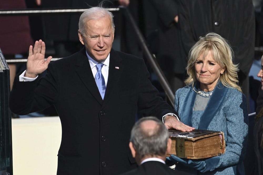 <p>Joe Biden is sworn in as the 46th president of the United States by Chief Justice John Roberts as Jill Biden holds the Bible during the 59th Presidential Inauguration at the U.S. Capitol in Washington, Wednesday, Jan. 20, 2021. (Saul Loeb/Pool Photo via AP)</p>