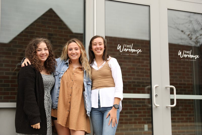 Jessica Wolfe (left), Brandi Osthimer (middle) and Maureen Kirk (right) pose in front of the location of the Fashion Merchandising Association&#x27;s resale pop-up shop. The team started planning more than a month before the event. Rylan Capper, DN