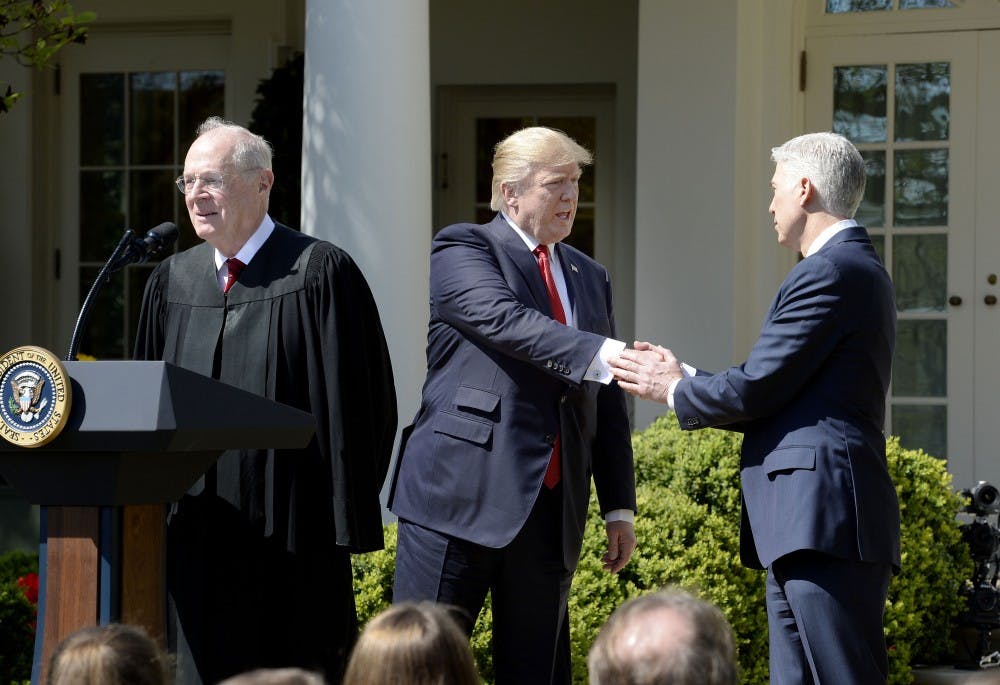 Justice Anthony Kennedy speaks as President Donald trump shakes hands with Neil Gorsuch ibefore a swearing in ceremony at the White House Rose Garden April 10, 2017 in Washington, D.C. (Olivier Douliery/Abaca Press/TNS) 