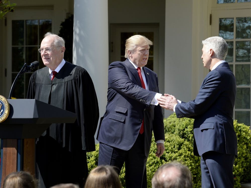 Justice Anthony Kennedy speaks as President Donald trump shakes hands with Neil Gorsuch ibefore a swearing in ceremony at the White House Rose Garden April 10, 2017 in Washington, D.C. (Olivier Douliery/Abaca Press/TNS) 